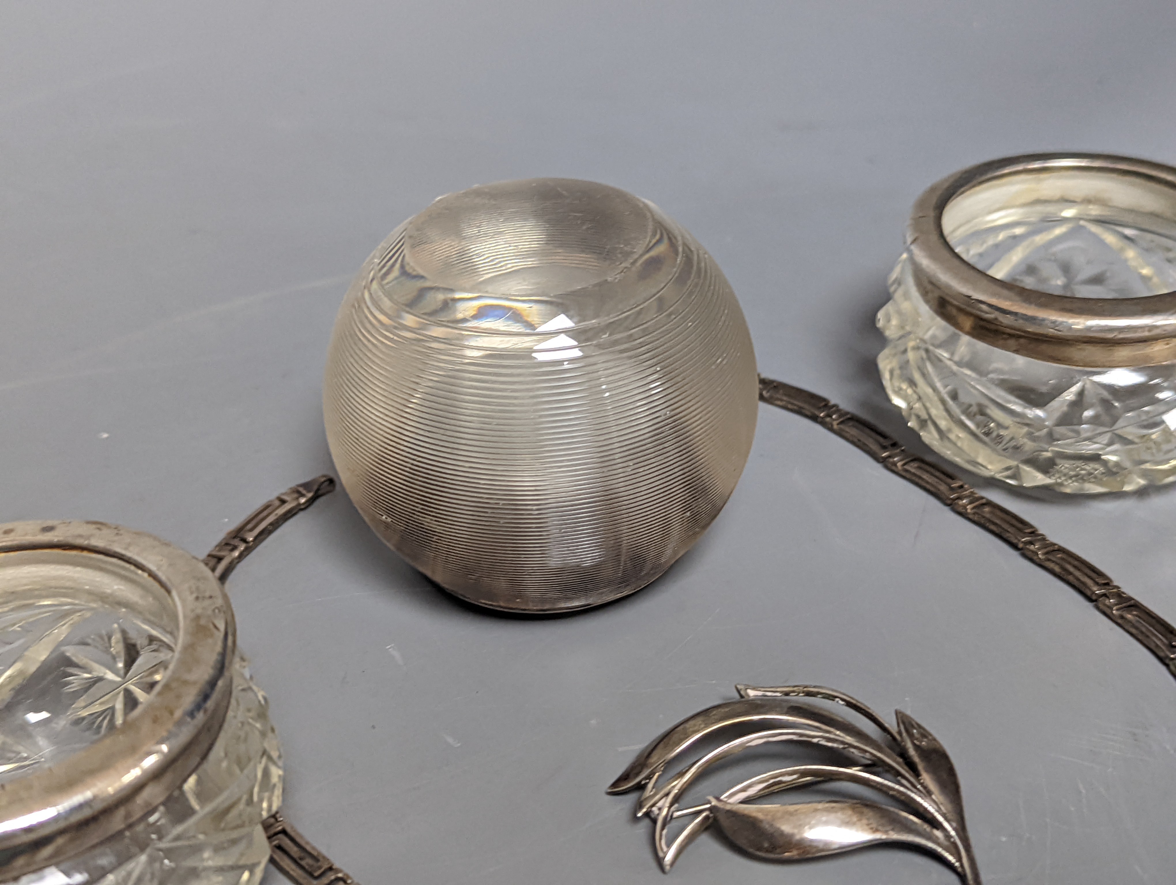 A Danish sterling foliate brooch, 5cm, a 925 'Greek Key' necklace and three silver mounted glass items including an early 20th century match tidy.